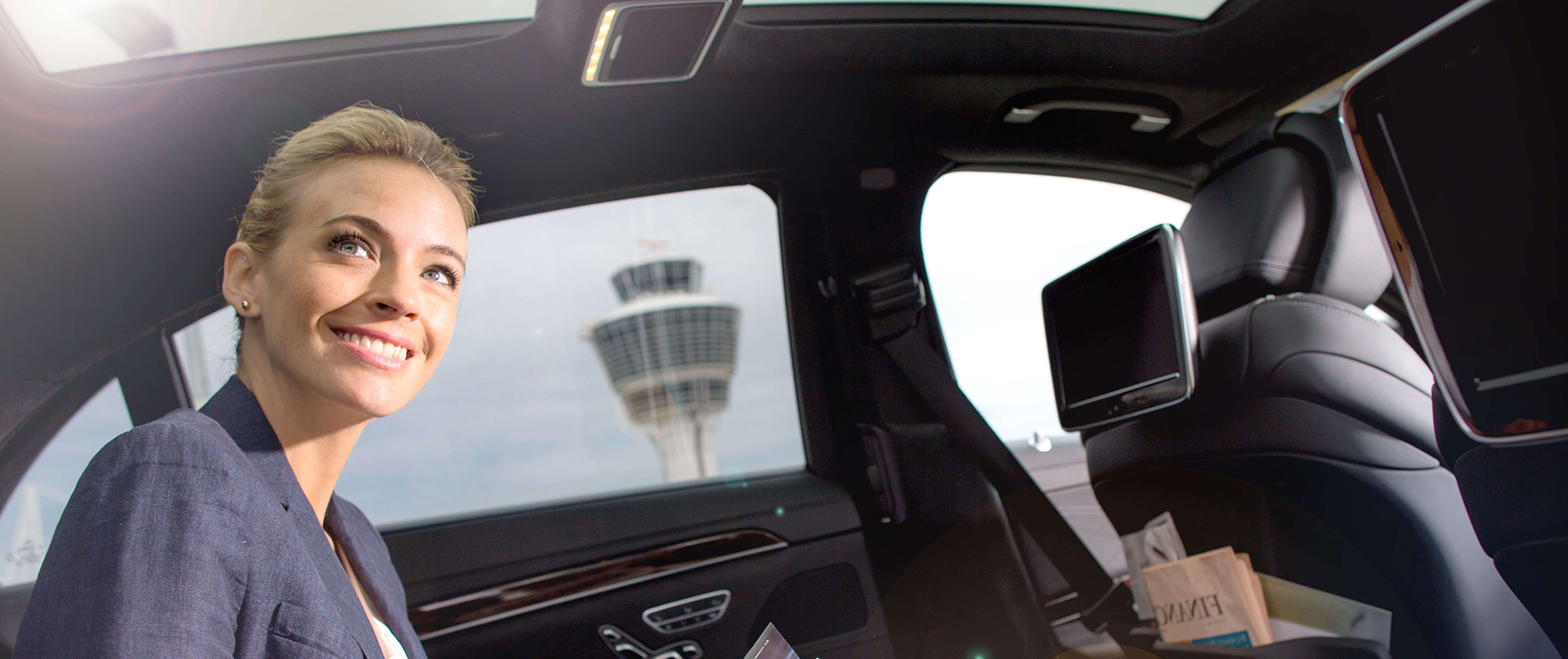 A woman smiling in a limousine.